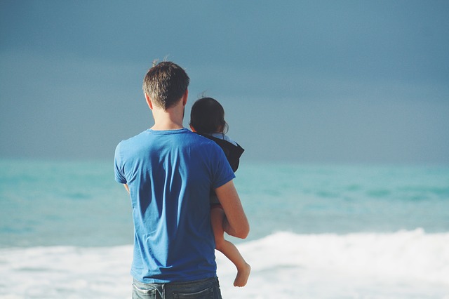 father and child on beach on father's day