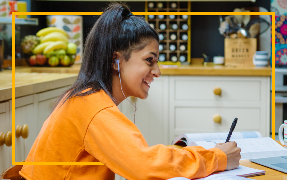 teenage-girl-smiling-working-at-laptop